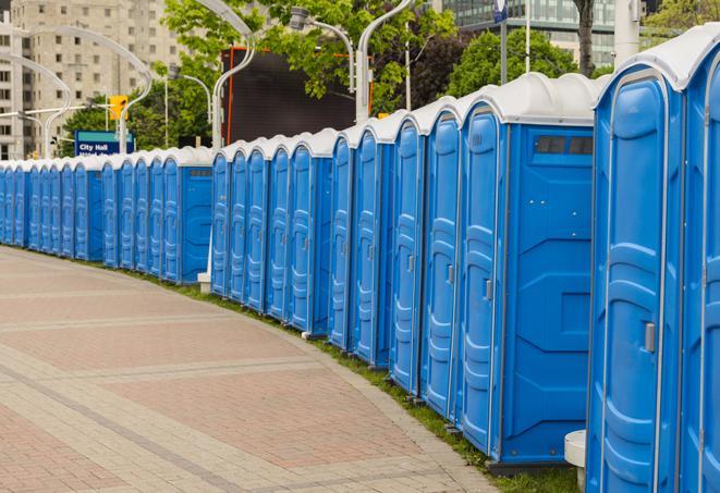 a row of portable restrooms ready for eventgoers in Feeding Hills